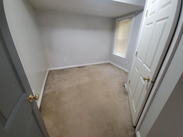 560 Lydia St NE, Grand Rapids, MI 49503 - unfurnished bedroom featuring light carpet and baseboards