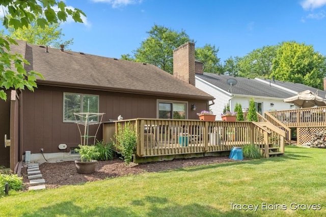 6305 Greenway Dr SE Unit 51, Grand Rapids, MI 49546 - rear view of property featuring a wooden deck, a yard, roof with shingles, and a chimney