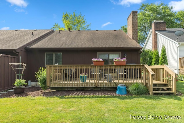 6305 Greenway Dr SE Unit 51, Grand Rapids, MI 49546 - back of house with a wooden deck, a shingled roof, and a yard