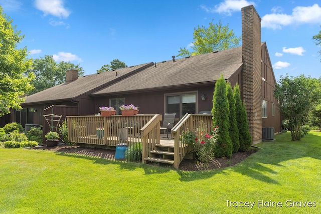 6305 Greenway Dr SE Unit 51, Grand Rapids, MI 49546 - back of property featuring a chimney, a wooden deck, a lawn, and roof with shingles