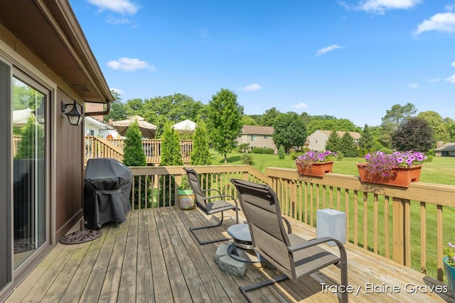 6305 Greenway Dr SE Unit 51, Grand Rapids, MI 49546 - wooden terrace with area for grilling and a yard