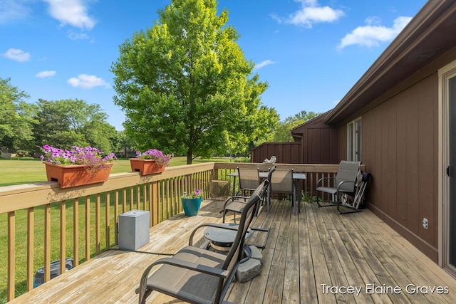 6305 Greenway Dr SE Unit 51, Grand Rapids, MI 49546 - deck with outdoor dining space and a yard