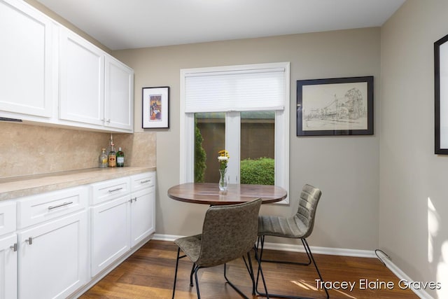 6305 Greenway Dr SE Unit 51, Grand Rapids, MI 49546 - dining space with dark wood-style flooring and baseboards