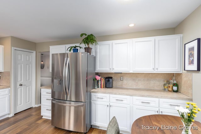 6305 Greenway Dr SE Unit 51, Grand Rapids, MI 49546 - kitchen with stainless steel fridge with ice dispenser, white cabinetry, backsplash, light countertops, and recessed lighting