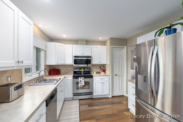 6305 Greenway Dr SE Unit 51, Grand Rapids, MI 49546 - kitchen featuring stainless steel appliances, light countertops, white cabinets, tasteful backsplash, and wood finished floors