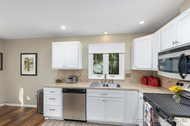 6305 Greenway Dr SE Unit 51, Grand Rapids, MI 49546 - kitchen featuring appliances with stainless steel finishes, light countertops, white cabinets, backsplash, and recessed lighting