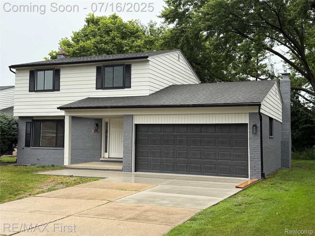 40866 Rinaldi Dr, Sterling Heights, MI 48313 - view of front of property featuring brick siding, a chimney, a front lawn, and concrete driveway