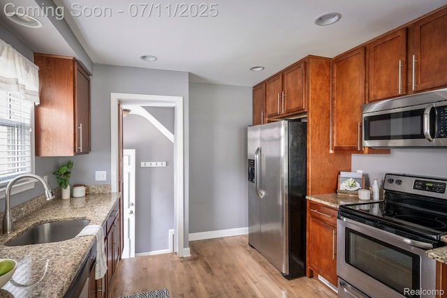 1416 N Alexander Ave, Royal Oak, MI 48067 - kitchen featuring appliances with stainless steel finishes, light wood-type flooring, light stone counters, brown cabinets, and recessed lighting