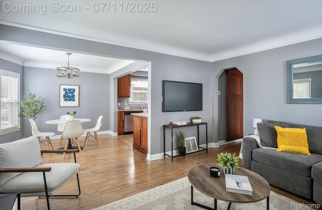 1416 N Alexander Ave, Royal Oak, MI 48067 - living room featuring a chandelier, light wood-type flooring, and arched walkways