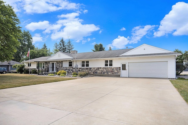236 Jeffrey St NE, Cedar Springs, MI 49319 - ranch-style home featuring an attached garage, driveway, a front yard, and stone siding