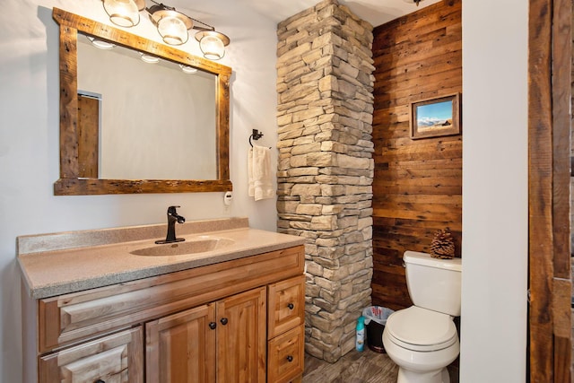 236 Jeffrey St NE, Cedar Springs, MI 49319 - bathroom with vanity, wood finished floors, and wooden walls