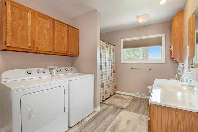236 Jeffrey St NE, Cedar Springs, MI 49319 - laundry area with washing machine and dryer and light wood-style flooring