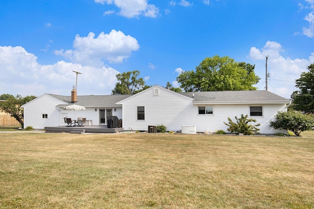 236 Jeffrey St NE, Cedar Springs, MI 49319 - rear view of property featuring a lawn, a deck, roof with shingles, and a chimney