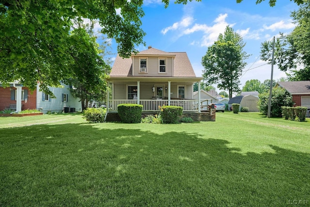 318 E Adrian St, Blissfield, MI 49228 - view of front of house with covered porch, a front yard, and roof with shingles