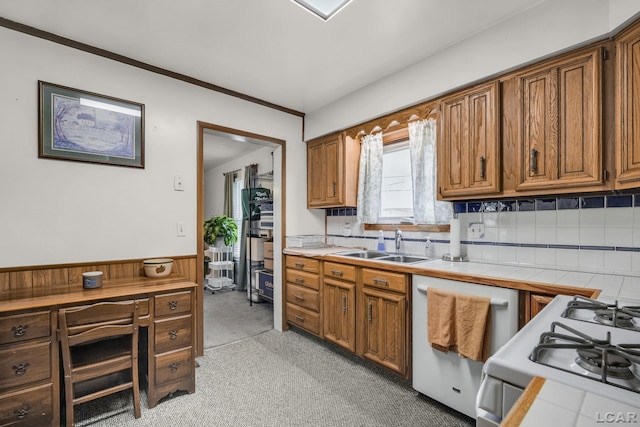 318 E Adrian St, Blissfield, MI 49228 - kitchen featuring dishwasher, range, brown cabinets, tasteful backsplash, and light carpet