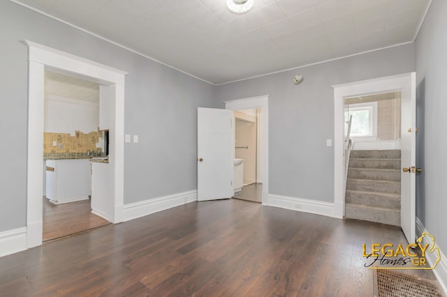 445 Prince St SE, Grand Rapids, MI 49507 - empty room featuring wood finished floors, stairs, and ornamental molding