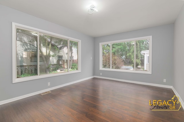 445 Prince St SE, Grand Rapids, MI 49507 - spare room featuring baseboards and dark wood-style flooring