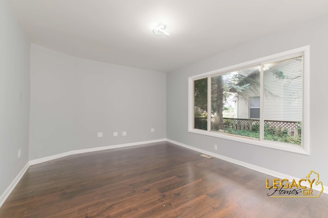 445 Prince St SE, Grand Rapids, MI 49507 - unfurnished room with dark wood finished floors and baseboards