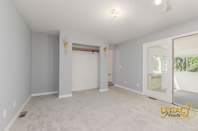 445 Prince St SE, Grand Rapids, MI 49507 - unfurnished bedroom with a textured ceiling, carpet flooring, and a closet