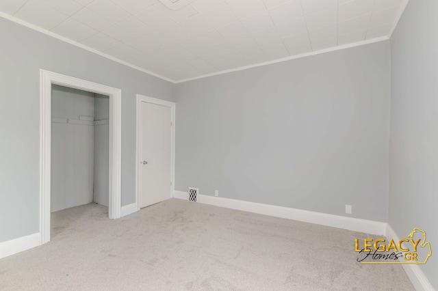 445 Prince St SE, Grand Rapids, MI 49507 - unfurnished bedroom featuring crown molding, carpet flooring, and a closet