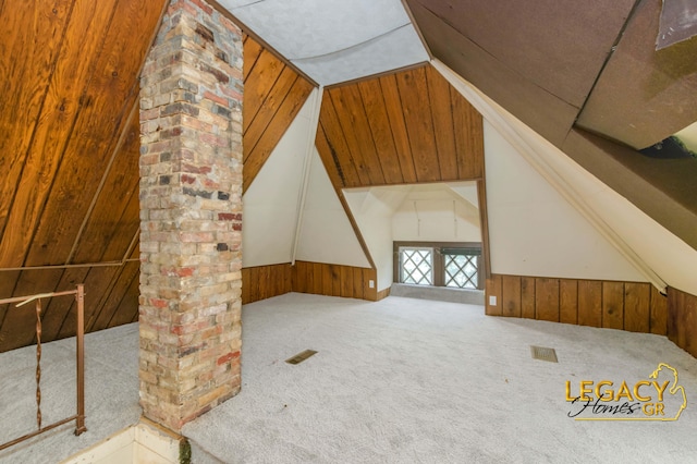 445 Prince St SE, Grand Rapids, MI 49507 - additional living space with wooden walls, lofted ceiling, carpet, ornate columns, and a wainscoted wall