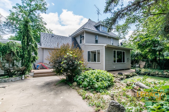 445 Prince St SE, Grand Rapids, MI 49507 - view of front of home with a wooden deck, a patio, and roof with shingles
