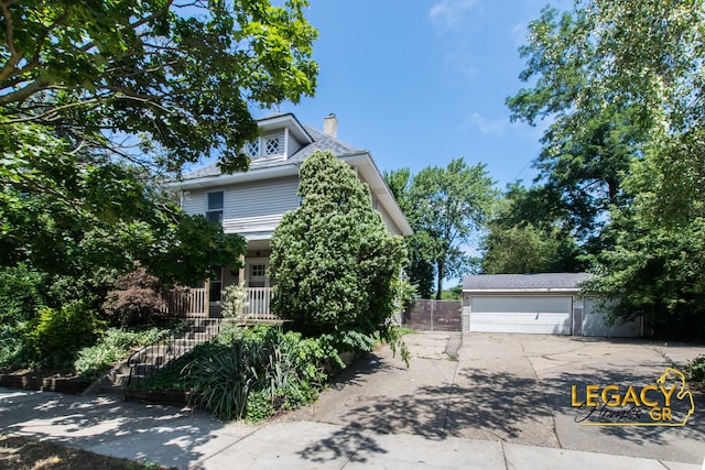 445 Prince St SE, Grand Rapids, MI 49507 - view of front facade with a chimney, a garage, and an outdoor structure