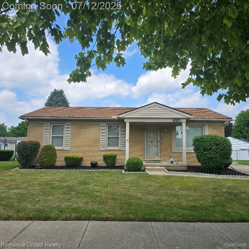 22128 Reinhardt St, Woodhaven, MI 48183 - view of front facade featuring a front lawn and brick siding
