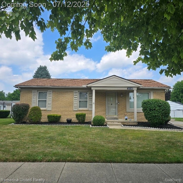 22128 Reinhardt St, Woodhaven, MI 48183 - view of front facade featuring a front lawn and brick siding