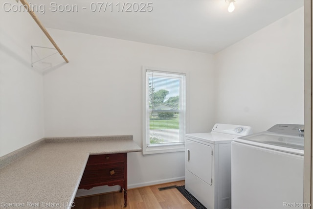 5045 Pine Knob Trl, Clarkston, MI 48346 - laundry area featuring washing machine and dryer and light wood-style floors