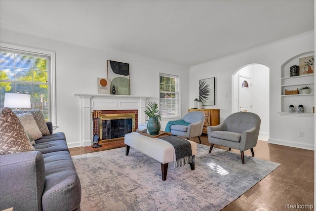 4800 Bishop St, Detroit, MI 48224 - living area with arched walkways, crown molding, wood finished floors, built in shelves, and a fireplace