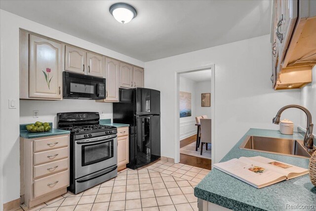 4800 Bishop St, Detroit, MI 48224 - kitchen with black appliances and light tile patterned floors