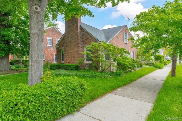 4800 Bishop St, Detroit, MI 48224 - view of side of property featuring brick siding and a chimney