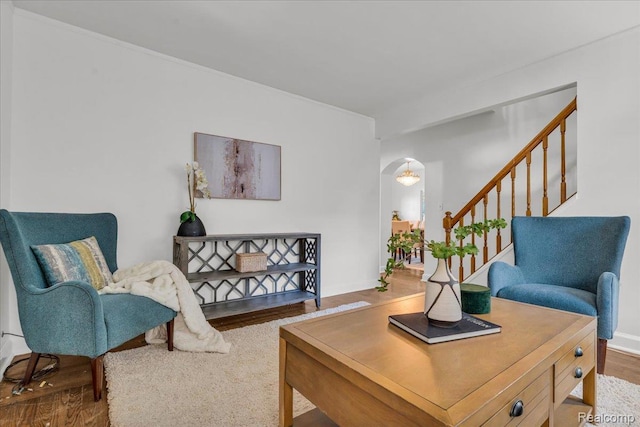 4800 Bishop St, Detroit, MI 48224 - living area featuring wood finished floors, arched walkways, and stairway