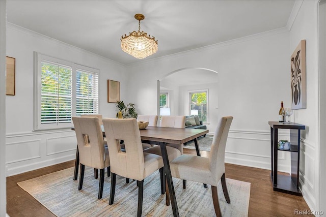 4800 Bishop St, Detroit, MI 48224 - dining space featuring arched walkways, a decorative wall, crown molding, a chandelier, and wood finished floors