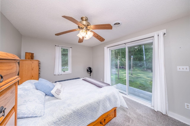 1051 Vallado Dr, Weidman, MI 48893 - carpeted bedroom featuring access to outside, ceiling fan, and a textured ceiling