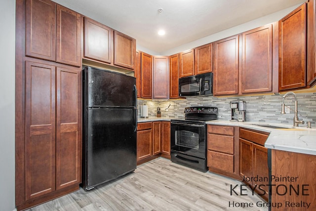 3508 River Run St, Wyoming, MI 49418 - kitchen with black appliances, light wood-style flooring, decorative backsplash, and brown cabinets