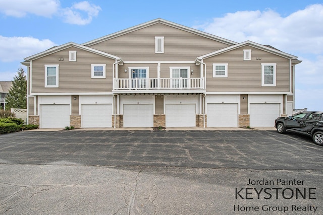 3508 River Run St, Wyoming, MI 49418 - view of property with stone siding and asphalt driveway