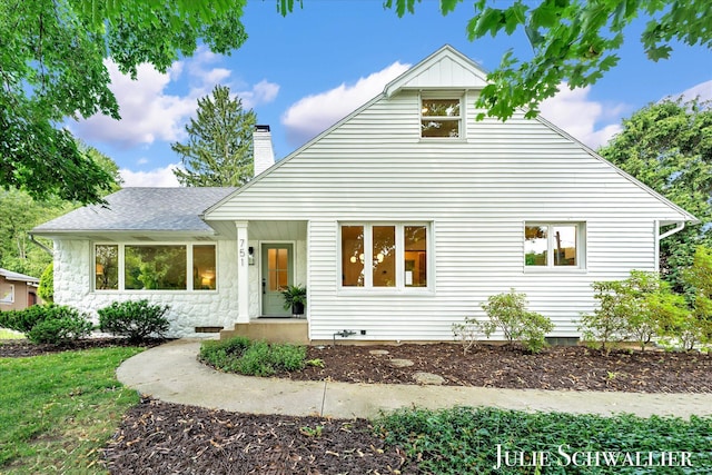 751 Old Gate Rd NW, Grand Rapids, MI 49504 - view of front of home featuring roof with shingles, a chimney, and stone siding