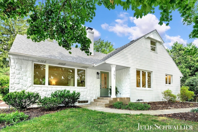 751 Old Gate Rd NW, Grand Rapids, MI 49504 - view of front of property with a shingled roof, a chimney, and a front yard