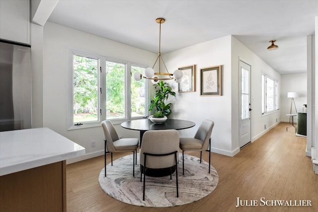 751 Old Gate Rd NW, Grand Rapids, MI 49504 - dining area with a chandelier and light wood-style flooring