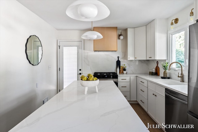 751 Old Gate Rd NW, Grand Rapids, MI 49504 - kitchen featuring appliances with stainless steel finishes, tasteful backsplash, light stone counters, dark wood finished floors, and white cabinets