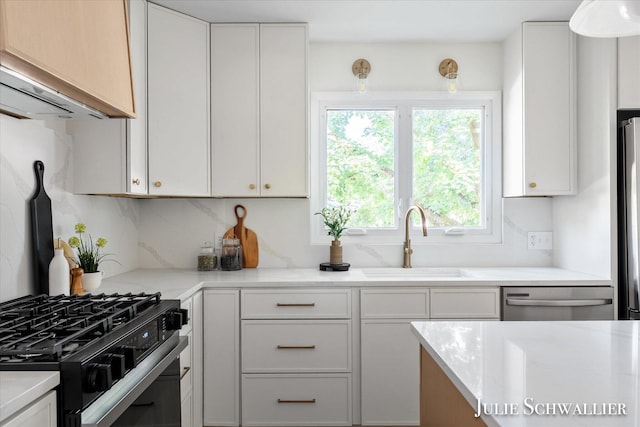 751 Old Gate Rd NW, Grand Rapids, MI 49504 - kitchen with stainless steel appliances, tasteful backsplash, and white cabinetry
