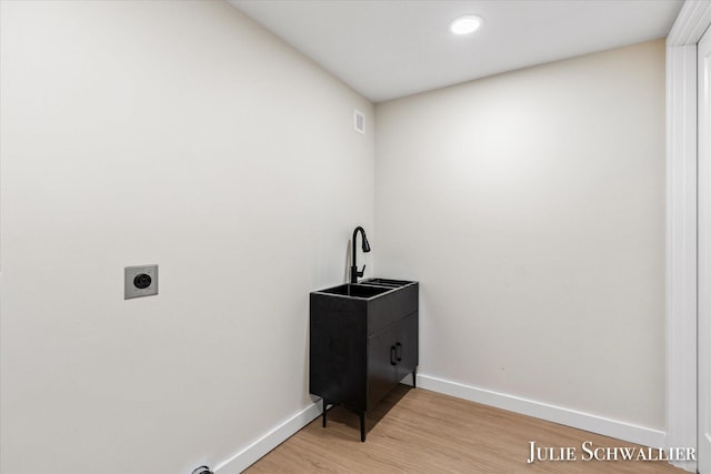 751 Old Gate Rd NW, Grand Rapids, MI 49504 - laundry room featuring hookup for an electric dryer, light wood finished floors, cabinet space, and recessed lighting