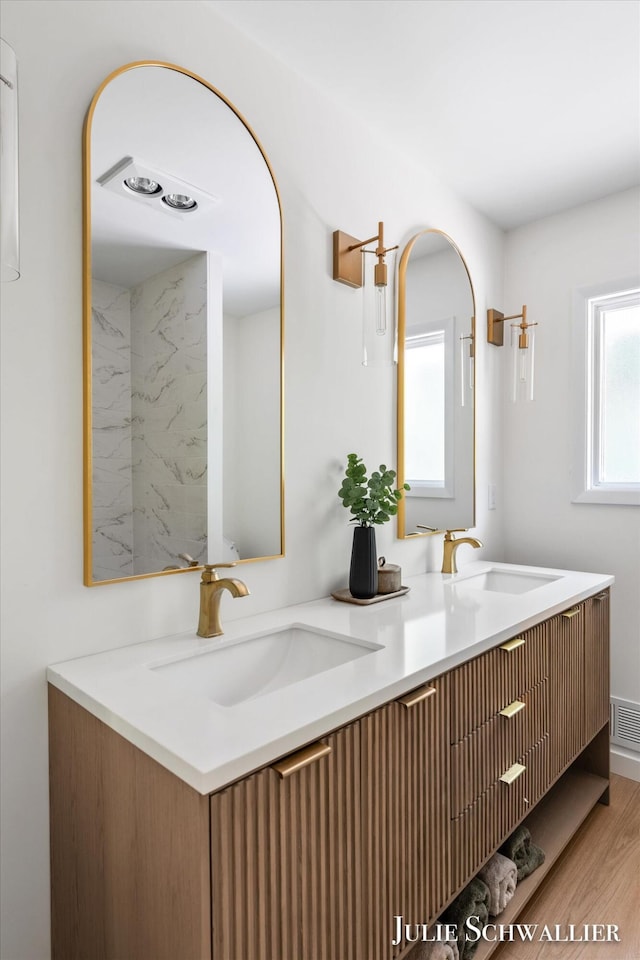 751 Old Gate Rd NW, Grand Rapids, MI 49504 - bathroom featuring double vanity and wood finished floors
