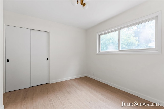 751 Old Gate Rd NW, Grand Rapids, MI 49504 - unfurnished bedroom featuring wood finished floors and a closet