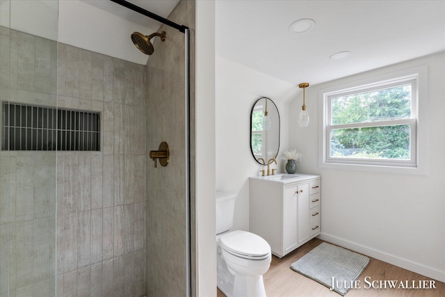 751 Old Gate Rd NW, Grand Rapids, MI 49504 - full bathroom with vanity, a tile shower, and wood finished floors