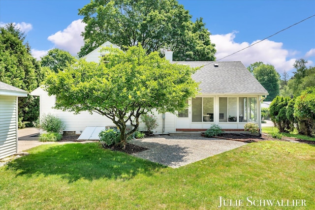 751 Old Gate Rd NW, Grand Rapids, MI 49504 - back of house featuring a lawn, roof with shingles, a chimney, and a sunroom