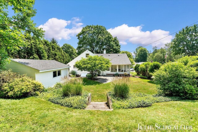 751 Old Gate Rd NW, Grand Rapids, MI 49504 - back of house featuring a lawn, covered porch, and roof with shingles