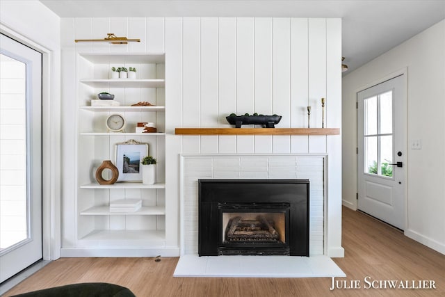 751 Old Gate Rd NW, Grand Rapids, MI 49504 - detailed view of wood finished floors, a tile fireplace, and built in shelves